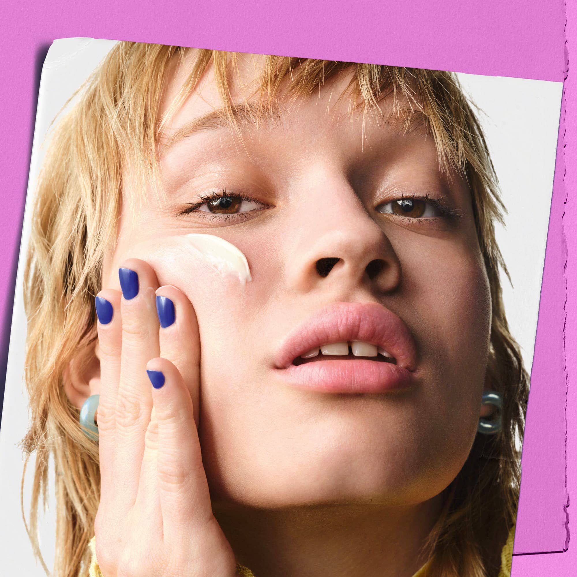 Модел, нанасящ Kiehl's Super Multi-Corrective Cream върху бузата си