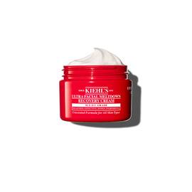 Червен буркан Kiehl’s Ultra Facial Meltdown Recovery Cream Whip, показващ текстура на бита сметана.