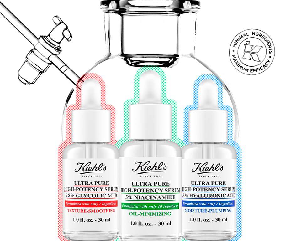 Три флакона серуми за грижа за кожата от Kiehl's, разположени един до друг, с различни цветни капачета.