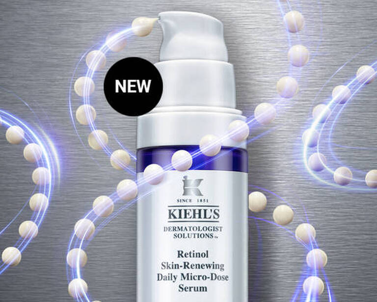 Alt text: A promotional image for Kiehl's new Retinol Skin-Renewing Daily Micro-Dose Serum, featuring the product bottle on a metallic background with small capsules and a syringe.